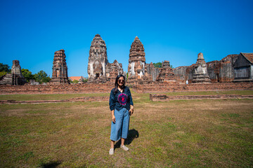 Beautiful asian woman backpack travel in ancient buddhist temple