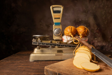 Provolone cheese, wonderful smoked provolone cheese on rustic wood and accessories, abstract background, selective focus.