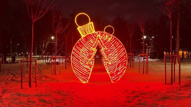 A Christmas ornament installation with a spruce shaped arch