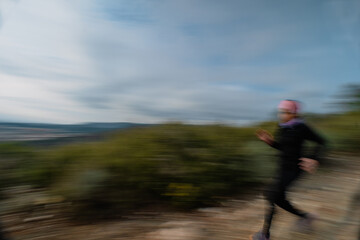 Fototapeta premium Motion Blur of Woman Trail Running