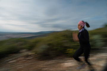 Motion Blur of Woman Jogging on Trail