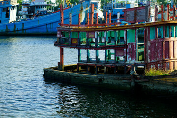 Weathered Boat Structure in Calm Waters with Colorful Reflections