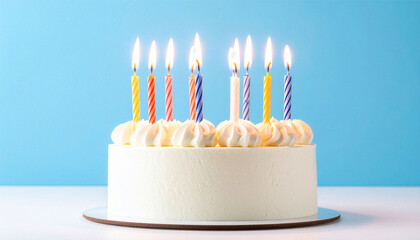 Birthday cake decorated with colorful candles on a light blue background