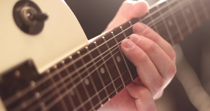 Acoustic guitar solo fingers on fretboard macro, guitar player playing music