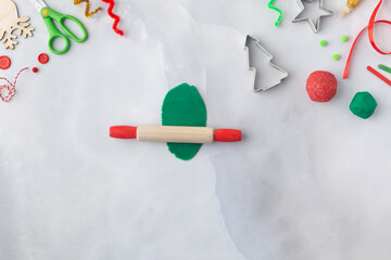 Play dough and Christmas decorations. Little child hands creating Christmas crafts. Holiday Art Activity for Kids. Sensory play for toddlers.