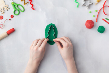 Play dough and Christmas decorations. Little child hands creating Christmas crafts. Holiday Art Activity for Kids. Sensory play for toddlers.
