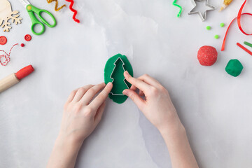 Play dough and Christmas decorations. Little child hands creating Christmas crafts. Holiday Art Activity for Kids. Sensory play for toddlers.