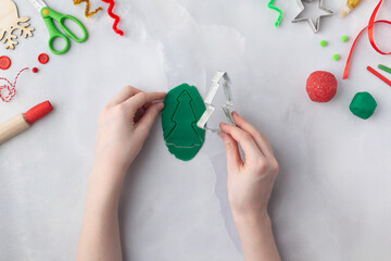 Play dough and Christmas decorations. Little child hands creating Christmas crafts. Holiday Art Activity for Kids. Sensory play for toddlers.