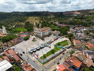 Historic town square in Brazil with colonial church and surrounding urban landscape