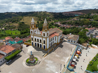 Historic town square in Brazil with colonial church and surrounding urban landscape