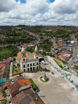 Historic town square in Brazil with colonial church and surrounding urban landscape