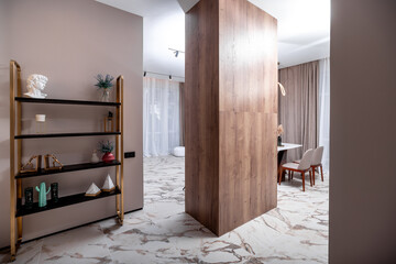 A white room with a brown door and a shelf with a vase on it