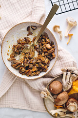 Finely chopped chanterelle, oyster and champignon mushrooms fried with carrots and onions