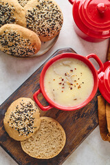Gourmet Liver Pate Appetizer with Sesame Seed Bagels and and Fresh Pea Shoots on Rustic Wooden Board
