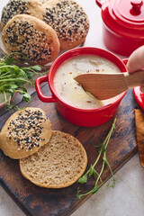 Gourmet Liver Pate Appetizer with Sesame Seed Bagels and and Fresh Pea Shoots on Rustic Wooden Board