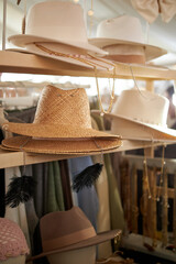 Stylish hats made of felt, fabric and straw are displayed at street market.