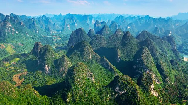 Aerial shot of spectacular karst mountain peaks with green valley natural landscape in Guilin, China.