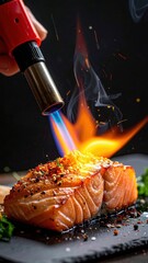 Close up Of Salmon Steak Being Torched With A Culinary Torch Indoors With Spices And Herbs