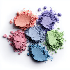 Colorful cosmetic powders scatter across white surface, showcasing vibrant texture details.