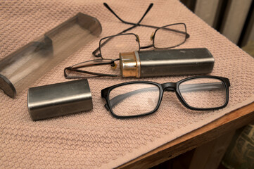 Old glasses lying on a piece of fabric