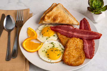 fried eggs  with turkey bacon  and hash browns