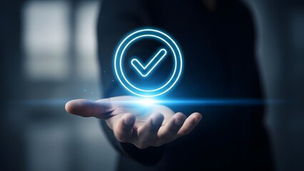 A glowing blue checkmark hovers above an outstretched hand in a dark room