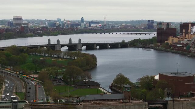 Boston, United States - 24 December 2025: Aerial view of the Charles River and Longfellow Bridge under a cloudy sky, with the city skyline in the distance.