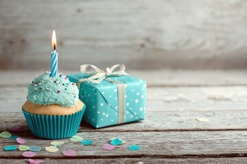 "Birthday Cupcake with Candle and Gift Box on Wooden Background"