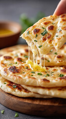 Traditional indian festive cuisine close-up: hand breaking freshly baked cheese-filled pie