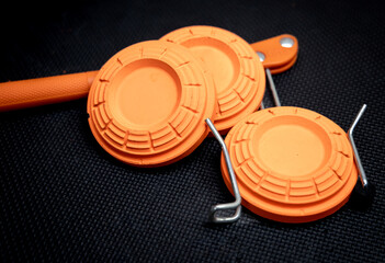 sporting clays stacked on a hand thrower isolated on black