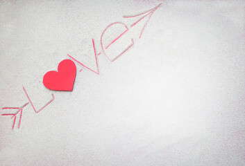 Word love made of heart and letters drawing on the sand background. Valentine's Day,  honeymoon, love holiday. Empty place. Flat lay. Mockup.