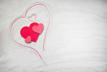 Creative sand texture with  wooden red hearts. (big and small) and heart drawing on the sand. Valentine's Day and love background. Empty place (pattern). Flat lay. Mockup.