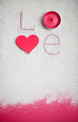 Word love made of heart, candle, letters drawing on the sand background. Valentine's Day, mother's, woman's day, honeymoon, vacation, summer background. Empty place. Flat lay. Mockup.