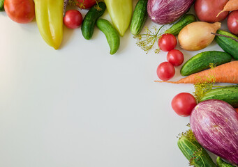 Ripe organic raw vegetables laid out on a white background. Top view.