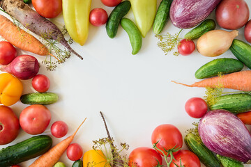 Ripe organic raw vegetables laid out on a white background. Top view.