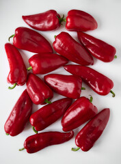 Ripe red bell peppers close-up on a white background.