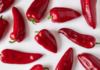 Ripe red bell peppers close-up on a white background.