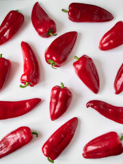 Ripe red bell peppers close-up on a white background.