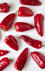 Ripe red bell peppers close-up on a white background.