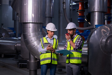 engineer under checking the industry cooling tower air conditioner is water cooling tower air chiller HVAC of large industrial building to control air system.	