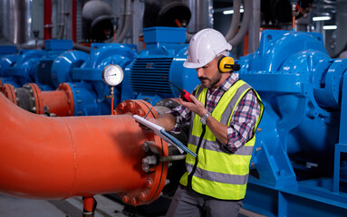 engineer under checking the industry cooling tower air conditioner is water cooling tower air chiller HVAC of large industrial building to control air system.	