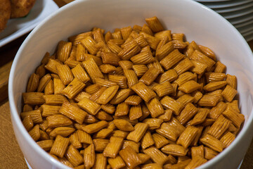 Bowl of Golden Cheese Puffs Snack.