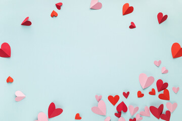 Saint Valentine or Mother's Day hearts decoration on blue background top view. Festive frame for...