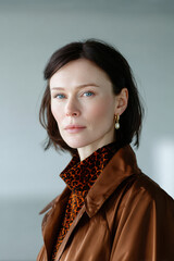 Confident woman wearing animal print and trench coat