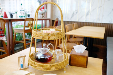 A tea set with desserts and a teapot.