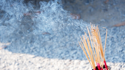 Smoke rises from the incense that is lit to worship sacred beings and make a wish.