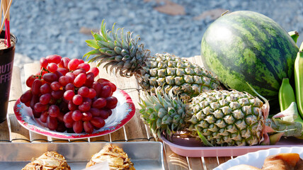 Arranging fruits as offerings to sacred beings.