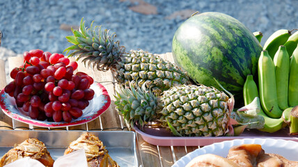 Arranging fruits as offerings to sacred beings.