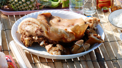 A pig&rsquo;s head for offering to sacred beings.