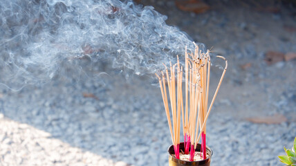 Smoke rises from the incense that is lit to worship sacred beings and make a wish.